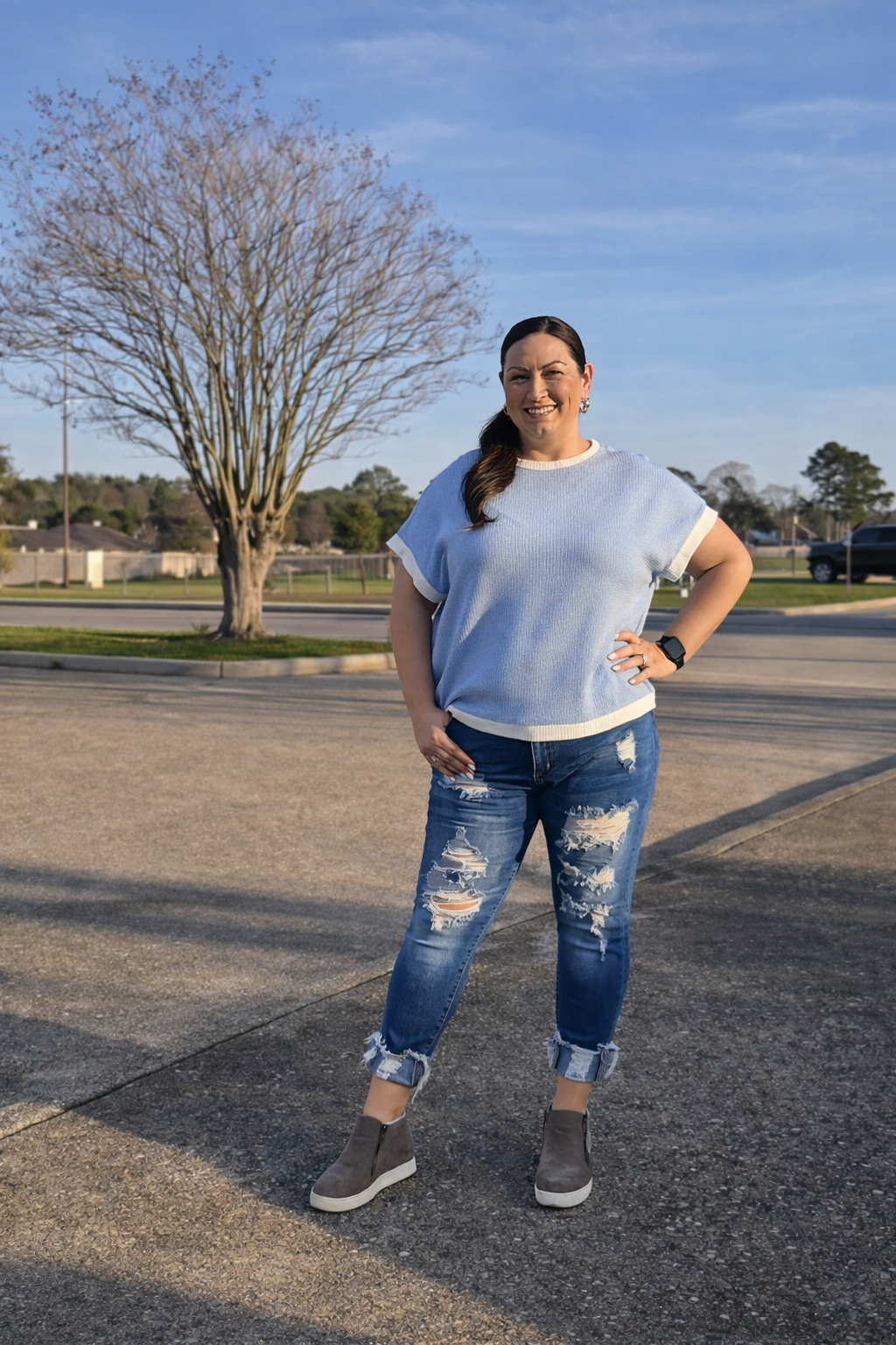 Women in blue shirt standing outside