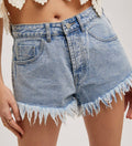 Denim shorts with lace top on a plain background